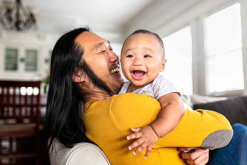 asian-american-father-hugging-his-little-son asian-american-father-hugging-his-little-son